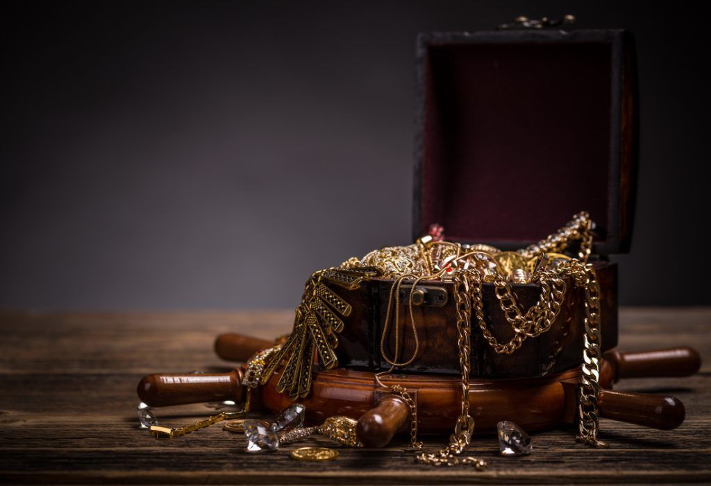 a brown box full of exquisite gold, diamonds, and silver jewelry for sale